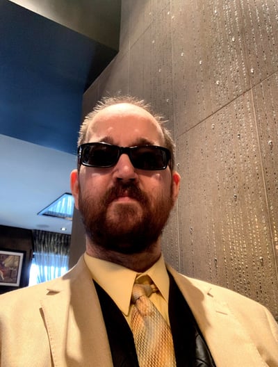 a man in a suit and sunglasses