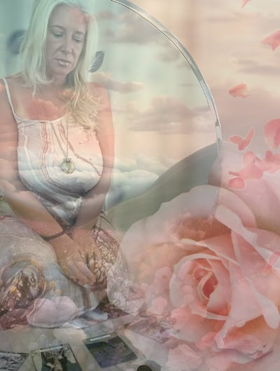 Maryann in IFS reflection with rose petals, mirror, and sky—ritual tarot cards at her feet
