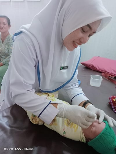 a nurse in a hospital gown is giving a patient a bandage