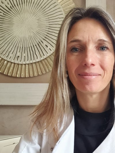 a woman in a white coat and black top