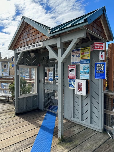 A gate with a sign that says Winslow wharf Marina