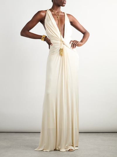 Elegant ivory draped gown with deep plunge neckline – luxury evening wear fashion statement.
