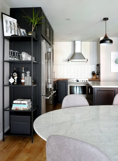 a kitchen with a marble table and chairs