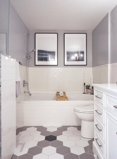 a bathroom with a white toilet and a hex pattern floor