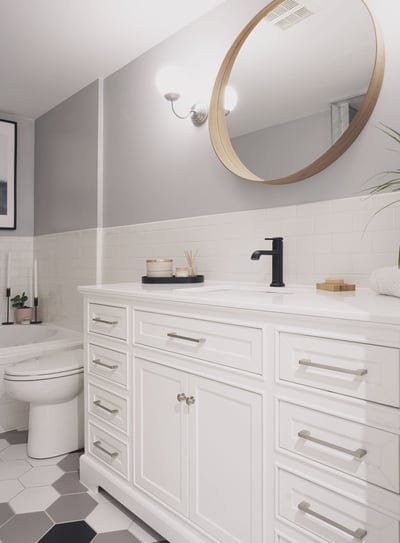 a bathroom with a white toilet and a large mirror