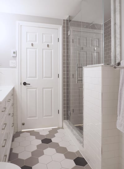 a bathroom with a shower and white vanity