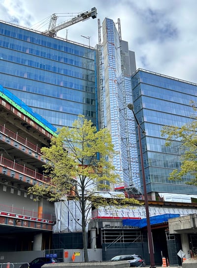 a large building with a crane in the background
