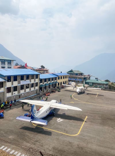 Airplane on the runway at Lukla airport preparing for takeoff.