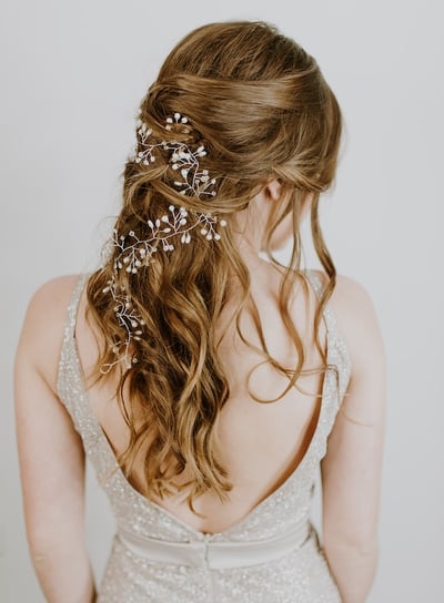 a woman with a wedding hair comb and a flower in her hair