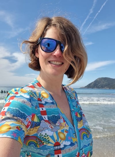 a woman in a colourful hand crafted shirt and sunglasses 