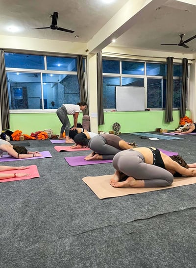 Yoga class in India with Eva leading the session as the teacher.