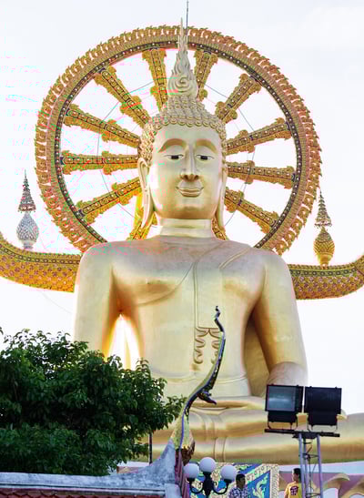 A close-up of the iconic Big Buddha statue on Koh Samui, Thailand. The golden Buddha