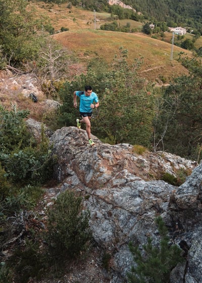 a man is running on a rocky trail