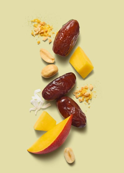 Food and packaging photography - dates and fruit and coconut on a green background