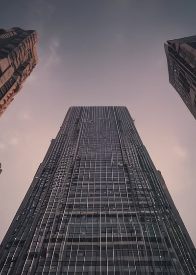 A modern skyscraper with the PwC logo is partially obscured by out-of-focus autumn leaves in the foreground. The building is set against a backdrop of a bright, cloudy sky.