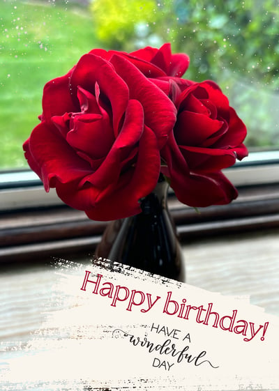 a vase with a red rose in it and a card with a happy birthday message