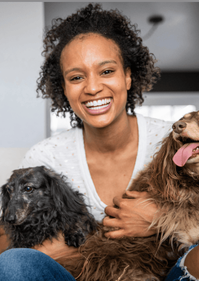 Young african american woman with two older dogs