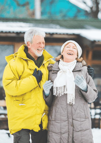 Laughing older couple outside in winter