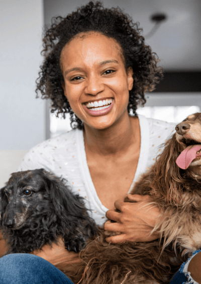 Young african american woman with two older dogs