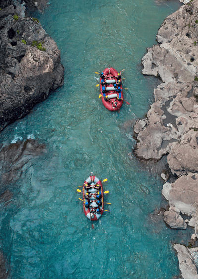 a group of people rafting down a river