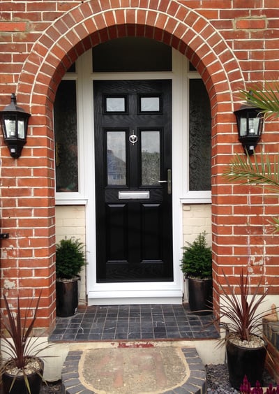a black front door 2 panel 2 square glass with side panels
