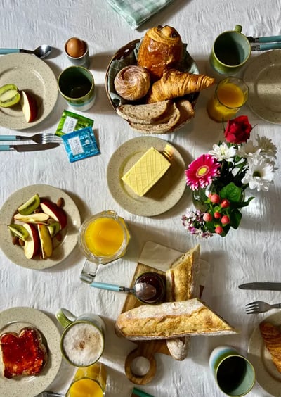 Set table with pastries, fruits, and drinks, perfect for a cozy breakfast or brunch