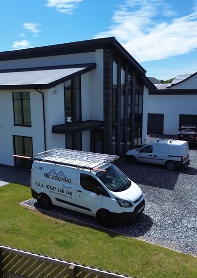 a van parked in front of a house