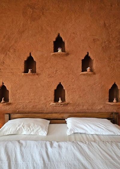 Rustic mudstone wall room with sit-out deck in Ilika Resorts