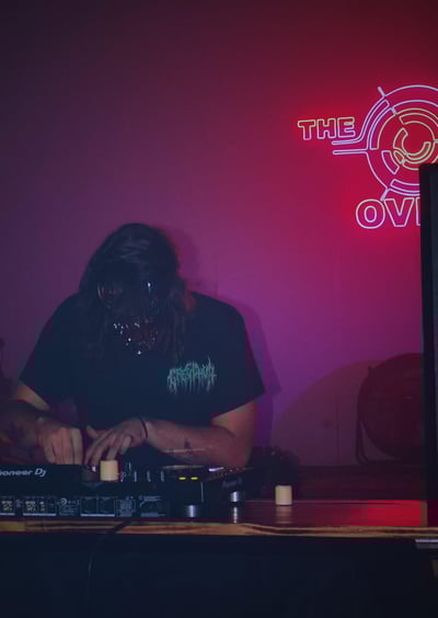 a man in a black shirt is playing a dj - creechur