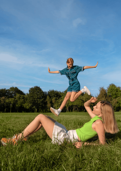 a woman and a child playing with a frisbee