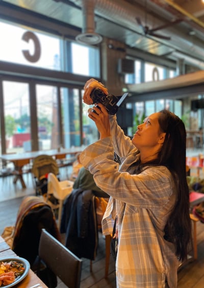 a woman taking a picture of herself in a restaurant