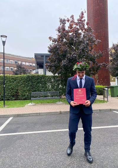 a man in a suit and tie is holding a certificate