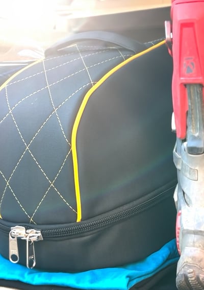 Detailed close-up of Remy helmet bag stitching and embossed logo, showcasing craftsmanship and brand