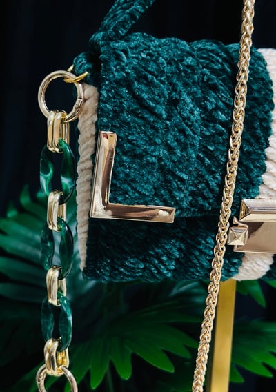 a handbag with a chain link chain and a chain link bracelet