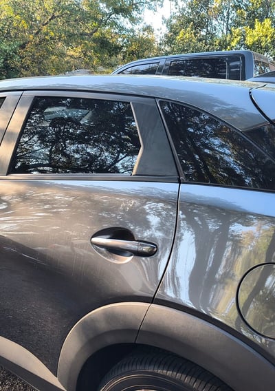 a car parked in a parking lot with a roof rack