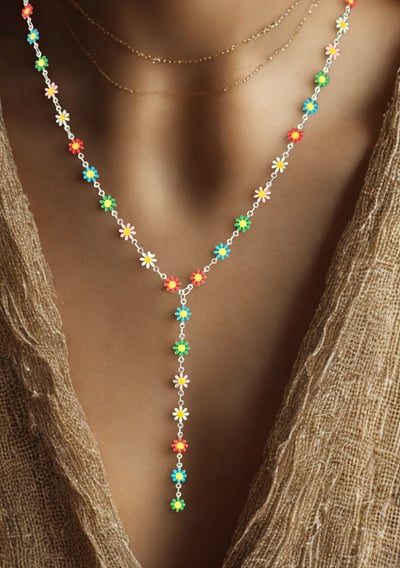 a woman wearing a necklace and a necklace with a flower