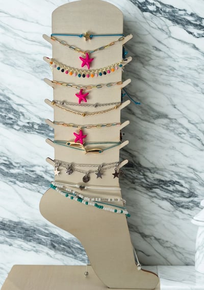 a display of jewelry with a wooden display case