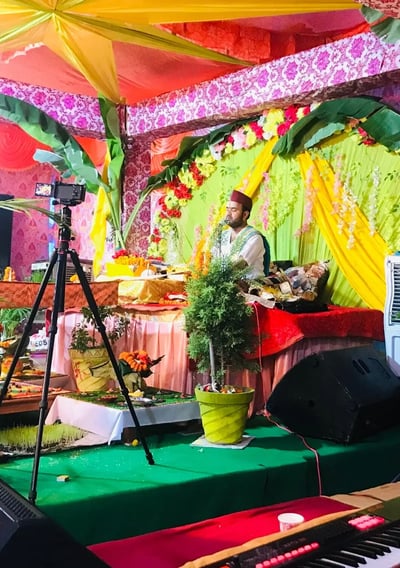 a man playing a keyboard in a brightly colored stage