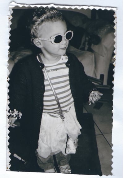 Black and white photo of young girl in extravagant fancy dress