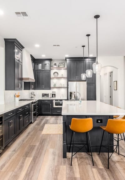 "Custom kitchen design with white quartz countertops, wood accents, and stainless steel finishes"