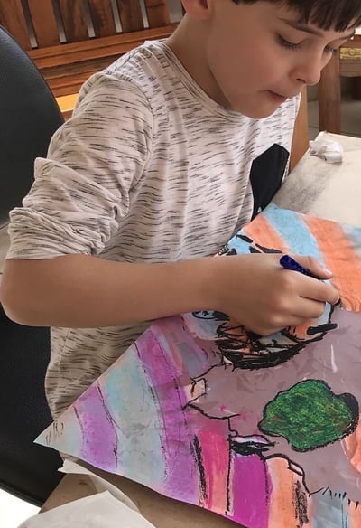 Crianças explorando cores em atividade de pintura artística.