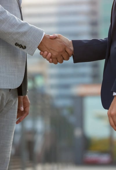 International business partners shaking hands to establish pharmacovigilance collaborationInternatio