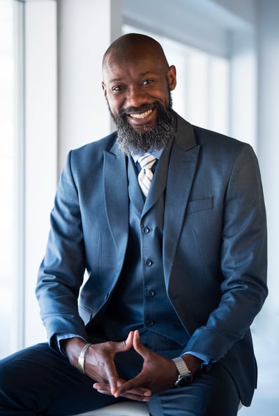a man in a suit and tie smiling