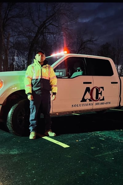 Security guard standing up Infront of a truck