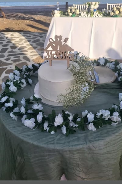 wedding cake on a table on the beach