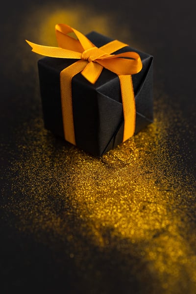 a black box with a yellow ribbon tied to it