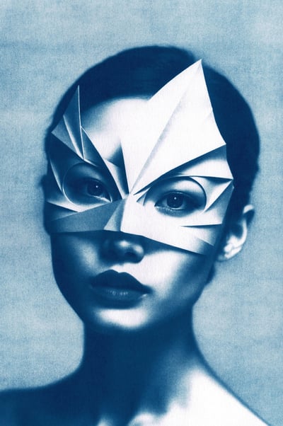 Close-up of a woman with dark hair, wearing an angular paper mask resembling a bird or superhero, ag