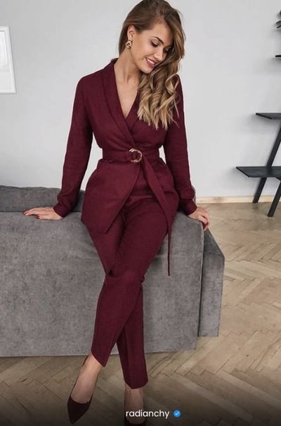 a woman in a red suit and heels