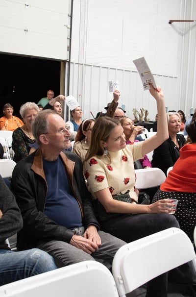 Attendees of the event bidding on pieces.