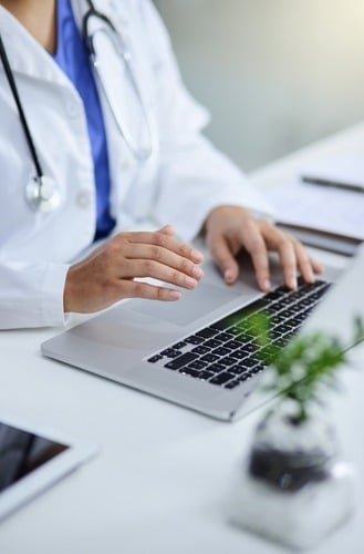 A doctor in front of her laptop